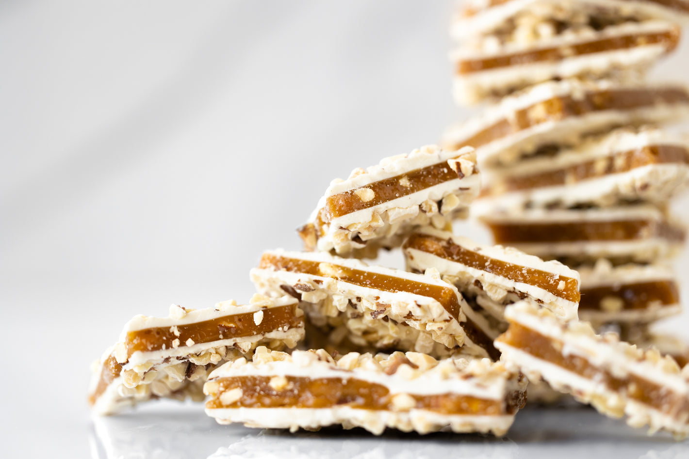 White chocolate coated English toffee topped with roasted almonds